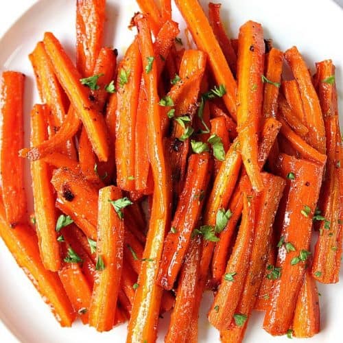 Brown sugar garlic roasted carrots on white plate.