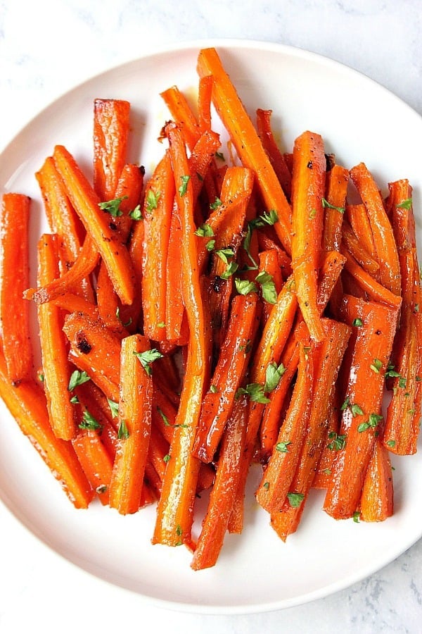 Brown sugar garlic roasted carrots on white plate.