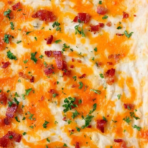 Casserole with cheddar and bacon on top.