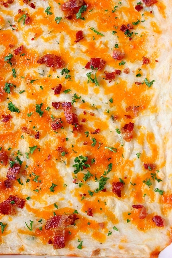 Casserole with cheddar and bacon on top.