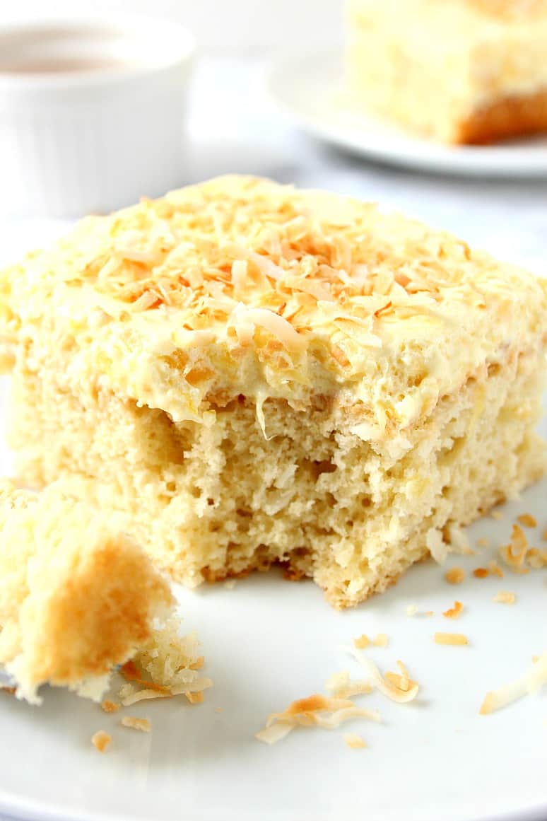 Coconut Pineapple Cake Recipe - sweet and delicious coconut cake with light and fluffy whipped pineapple frosting! Perfect Summer dessert!