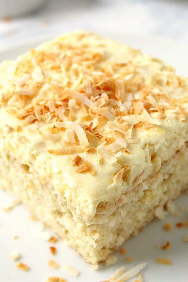 Coconut Pineapple Cake Cake piece on plate.