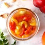 Marinated roasted red peppers in a jar.