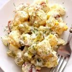 Dill Pickle Potato Salad on white plate with fork.