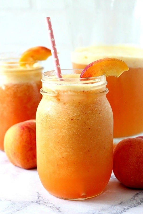 Peach Aqua Fresca in mason jar with straw.