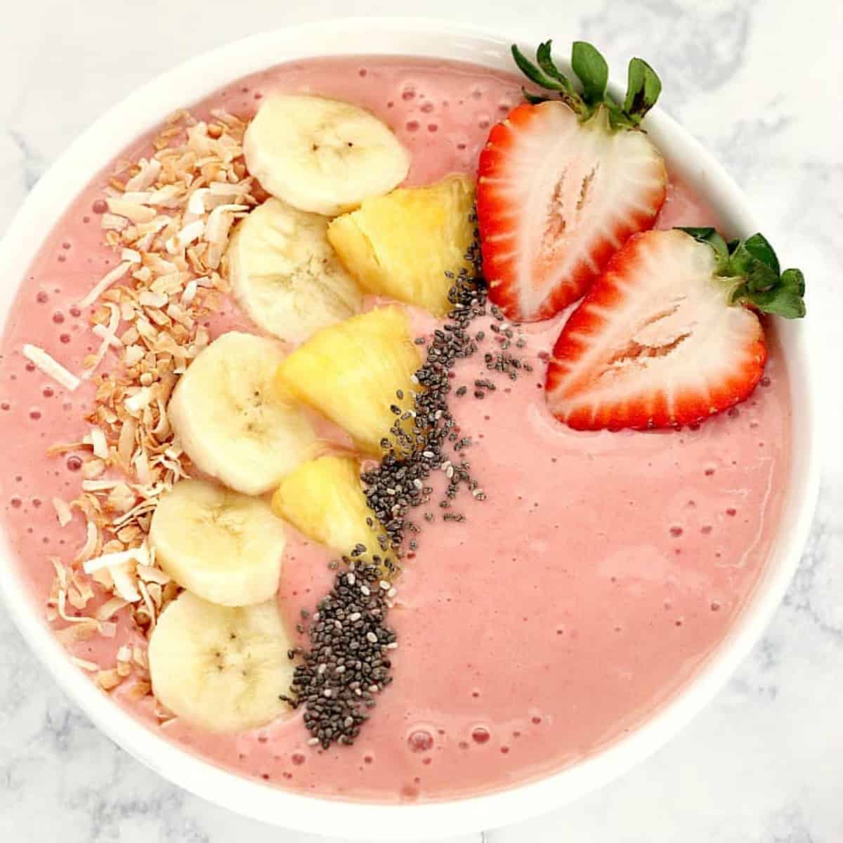 Smoothie with fruit in a white bowl.