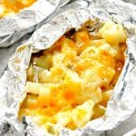 Cheesy Potato Foil Packets open placed on baking sheet.