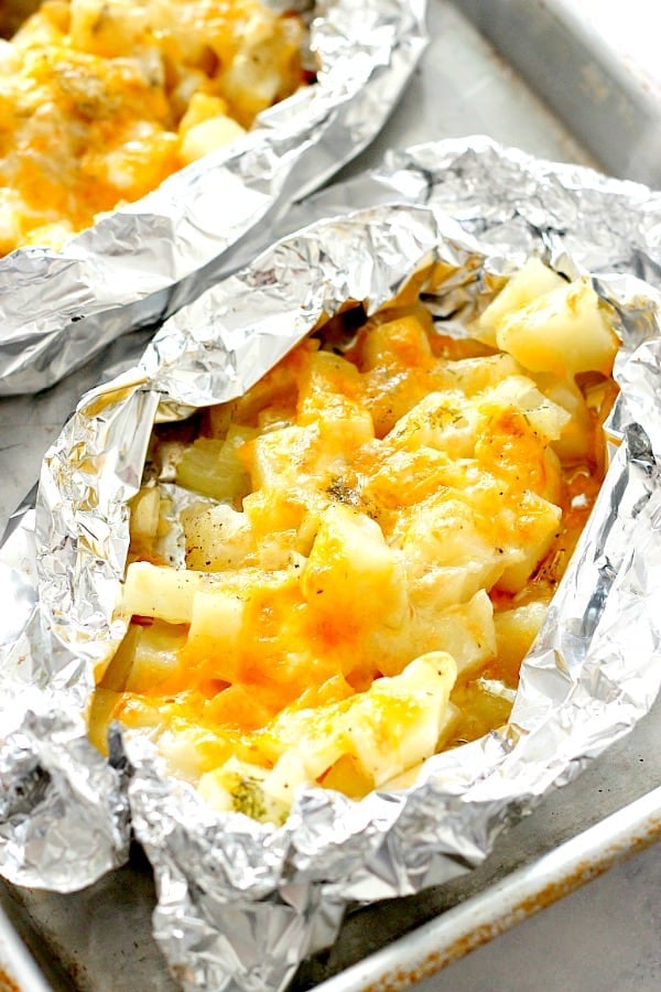 Cheesy Potatoes Foil Packets recipe Foil Packets open placed on baking sheet.