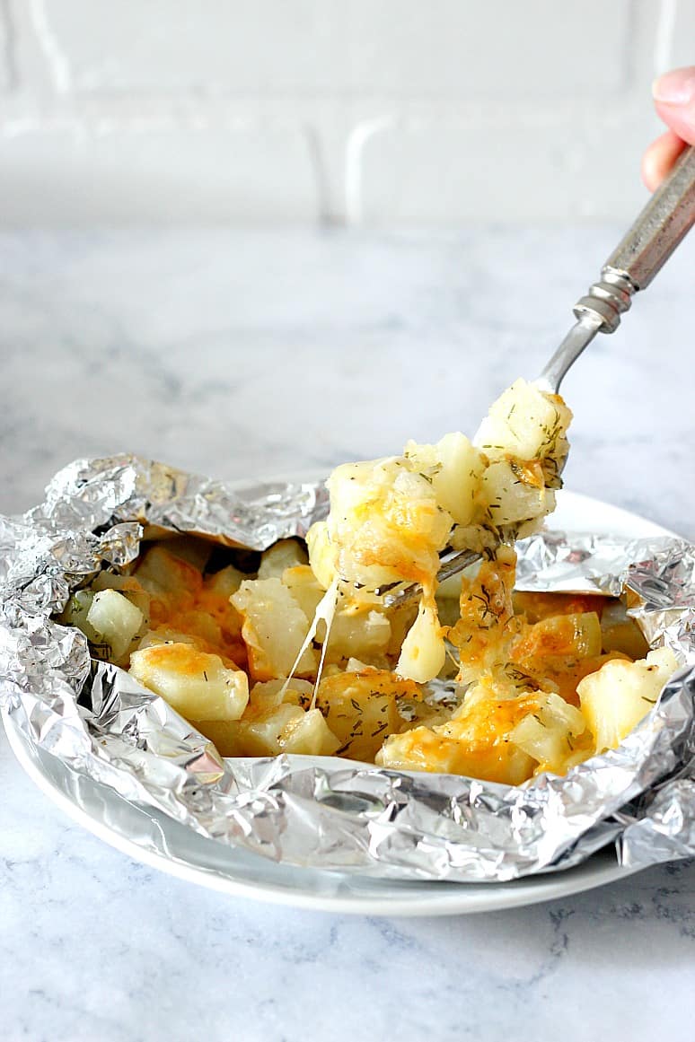 Potatoes on a fork from foil packets.