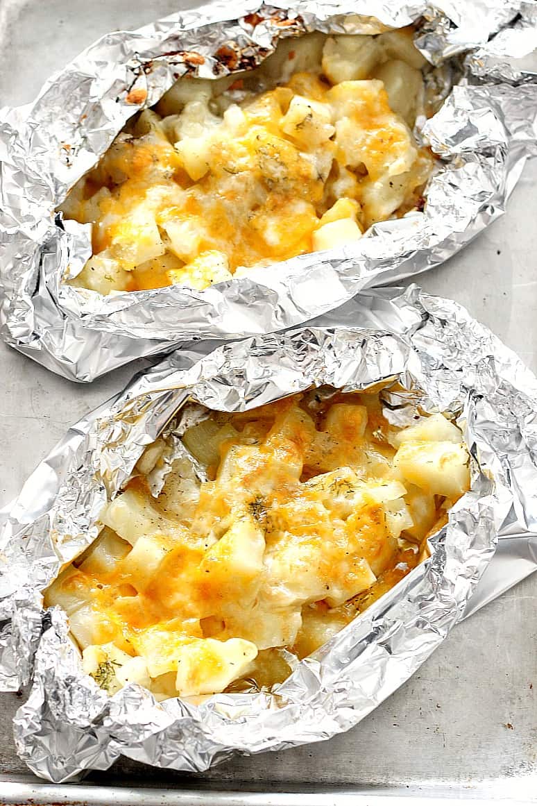 Cheesy Potatoes Foil Packets on baking pan.