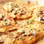 Creamy Mushroom Garlic Chicken cutlets in a pan with sauce.