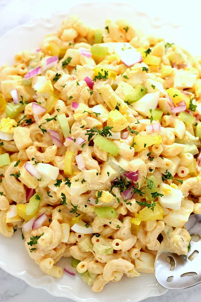 Deviled Egg Macaroni Salad Recipe - creamy pasta salad with macaroni, eggs, celery, pickles, red onion and delicious mustard paprika dressing! 