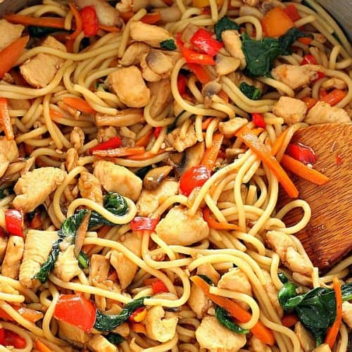 Chicken, veggies and noodles in a skillet.