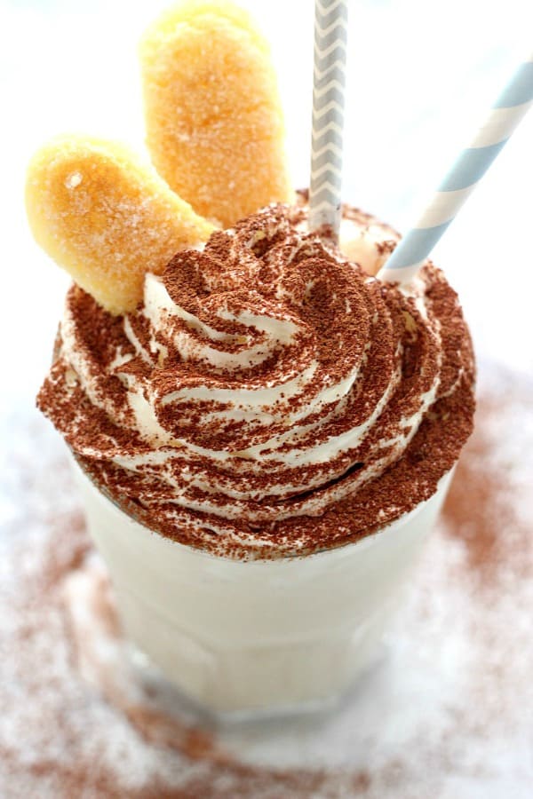 Tiramisu Milkshake Recipe - sweet and creamy shake that tastes just like Tiramisu! Serve with ladyfingers and enjoy! Tiramisu Shake in a tall glass.