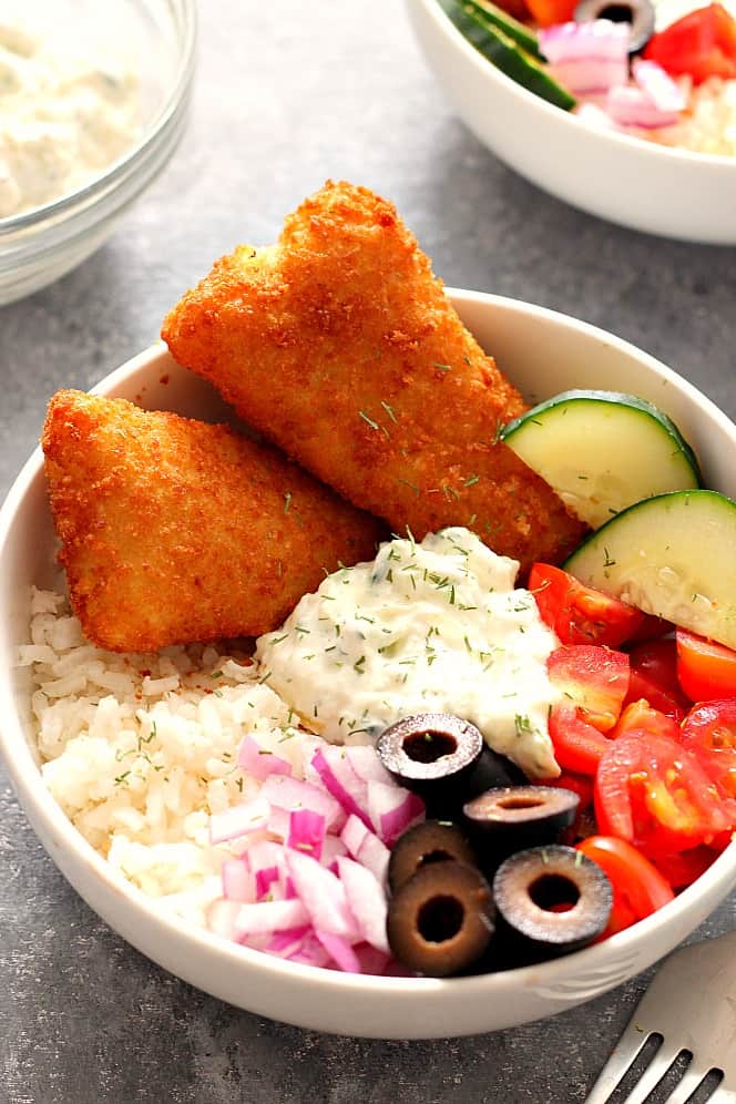 Crispy Fish Greek Rice Bowls Recipe - chopped vegetables, cucumber dill sauce and rice served with breaded fish fillets are a delicious lunch or dinner idea for busy weekdays. 