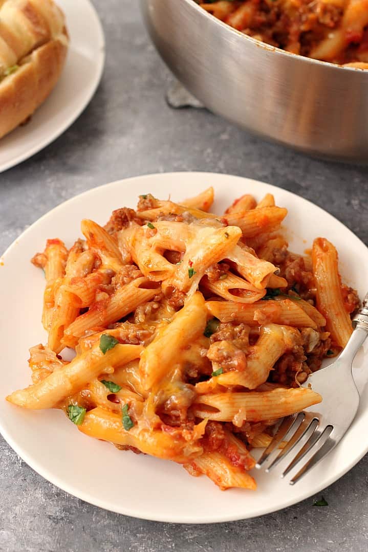 One Pot Cheesy Sausage Penne Recipe - hearty and satisfying one pan pasta dinner. Italian sausage, quick tomato sauce and penne pasta with cheesy topping is perfect for busy weeknights. 