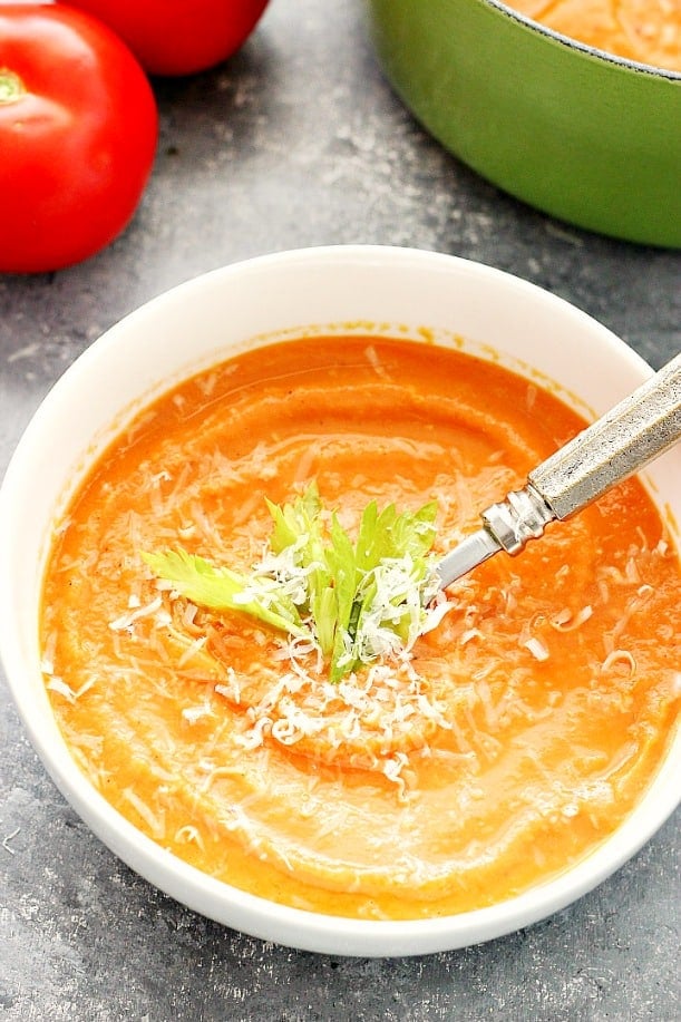 Creamy Roasted Tomato Soup Recipe - rich in flavor creamy soup that is the best served with thick grilled cheese. This tomato soup is healthy and made with a handful of ingredients. Overhead shot of tomato soup in white bowl.