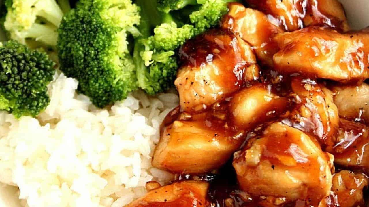 Close up shot of teriyaki chicken with rice and steamed broccoli. 