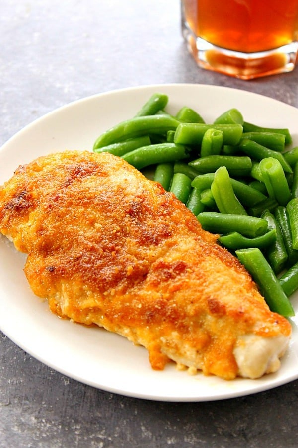 BBQ Cheddar Chicken on white plate, next to green beans.