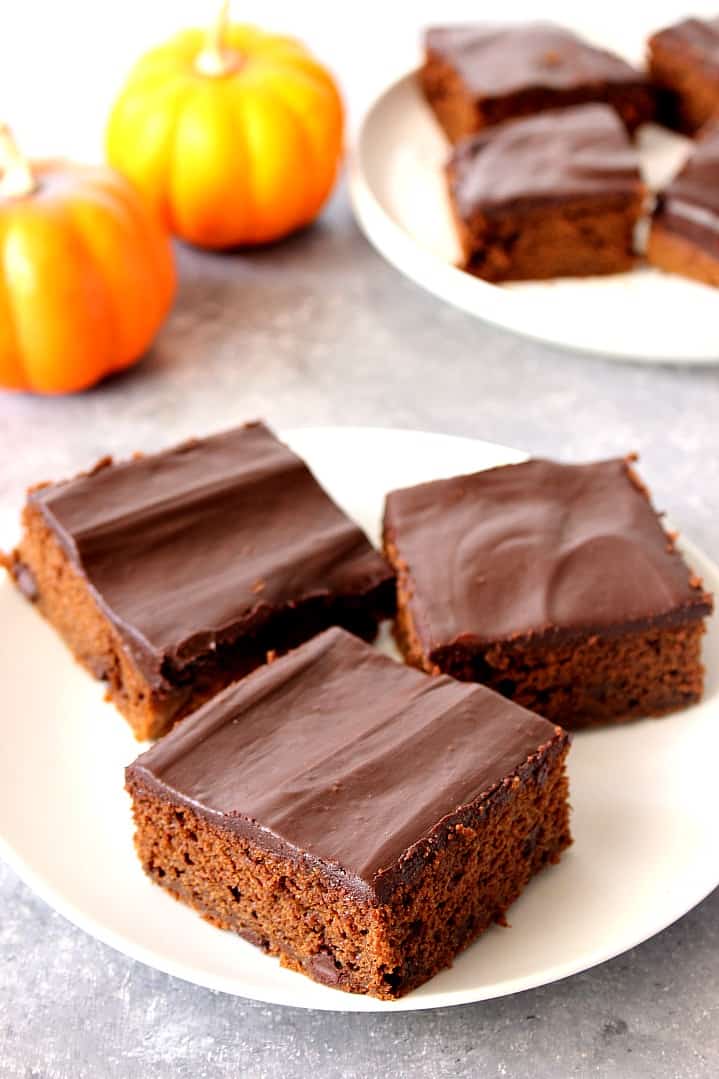 Chocolate Pumpkin Cake Recipe - quick and easy pumpkin spiced chocolate cake with two-ingredient chocolate ganache topping. Chocolate Pumpkin Cake pieces on a white plate.