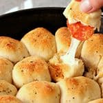 Pulling Pizza roll from Skillet.