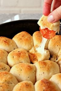 Pulling Pizza roll from Skillet.