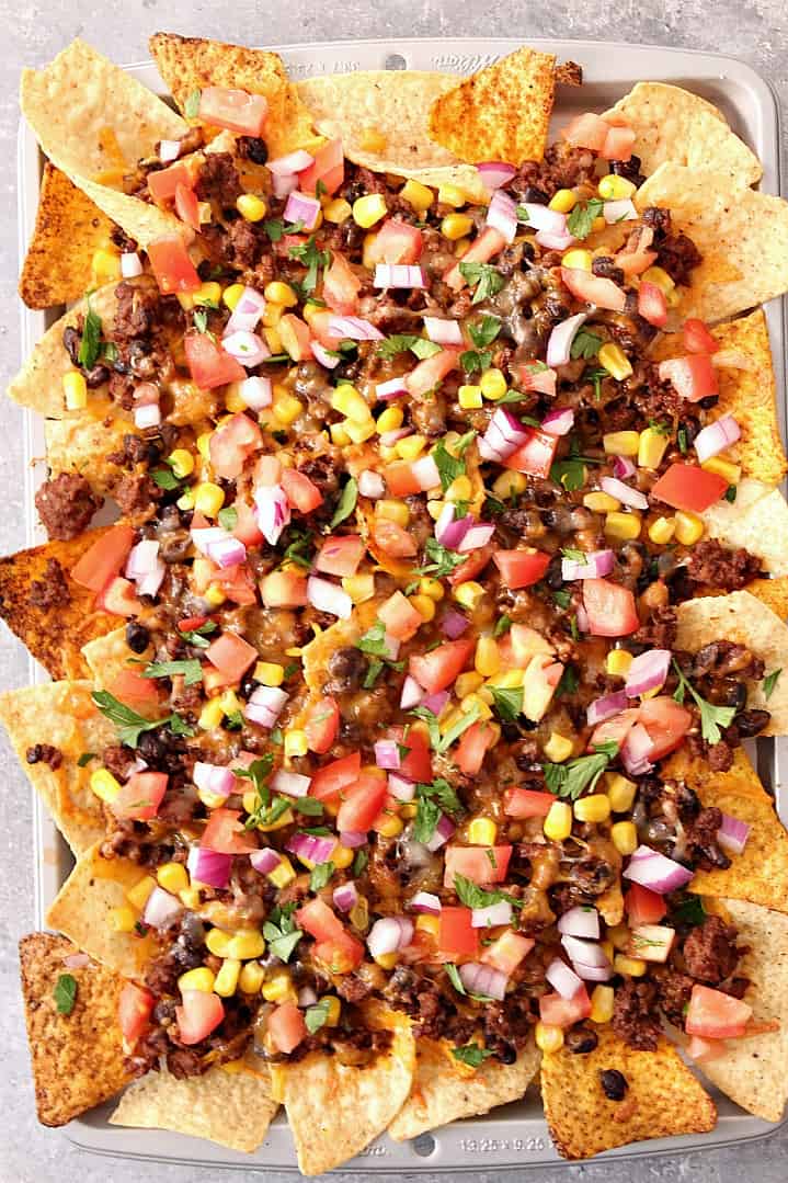 Large sheet pan with baked nachos.