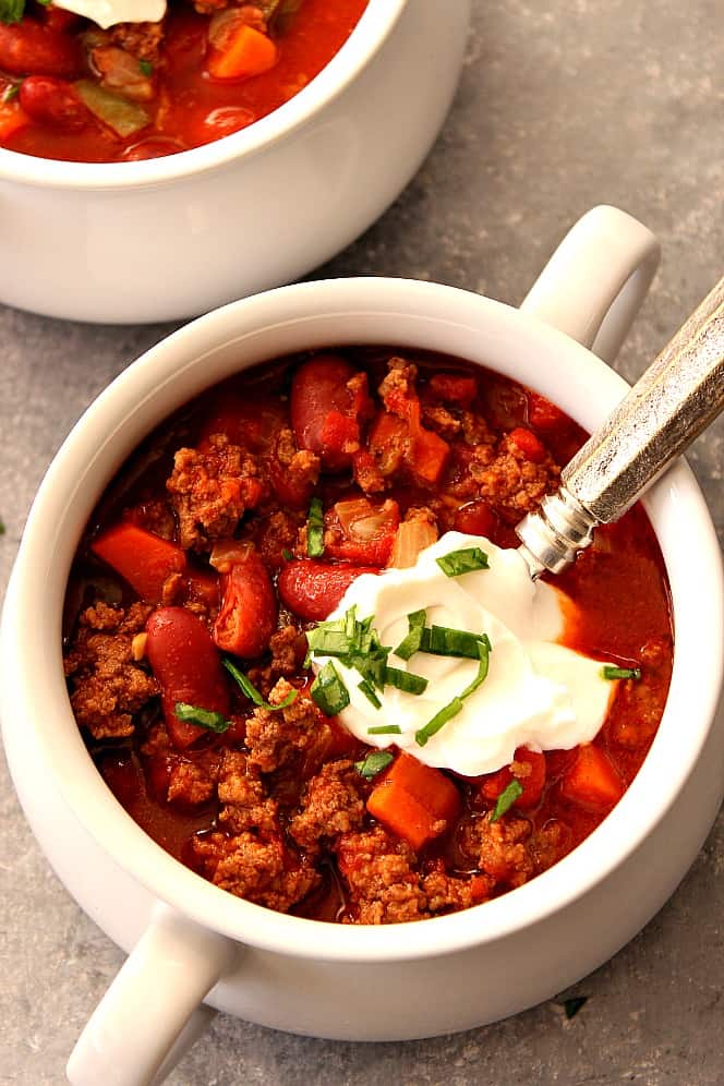 Overhead shot of beef chili with beans in soup bowl.