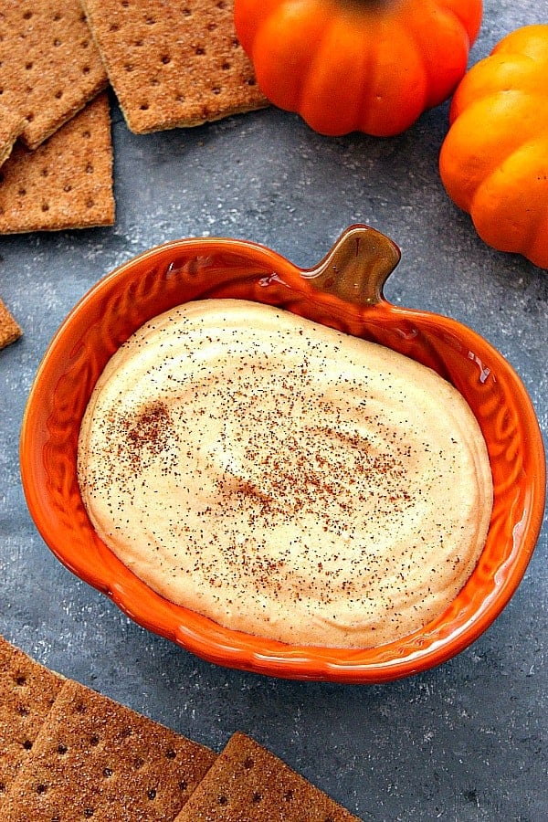 Pumpkin Cheesecake Dip - a sweet and creamy dip that tastes just like pumpkin cheesecake! No whipped topping needed! Pumpkin cheesecake dip in orange pumpkin bowl.