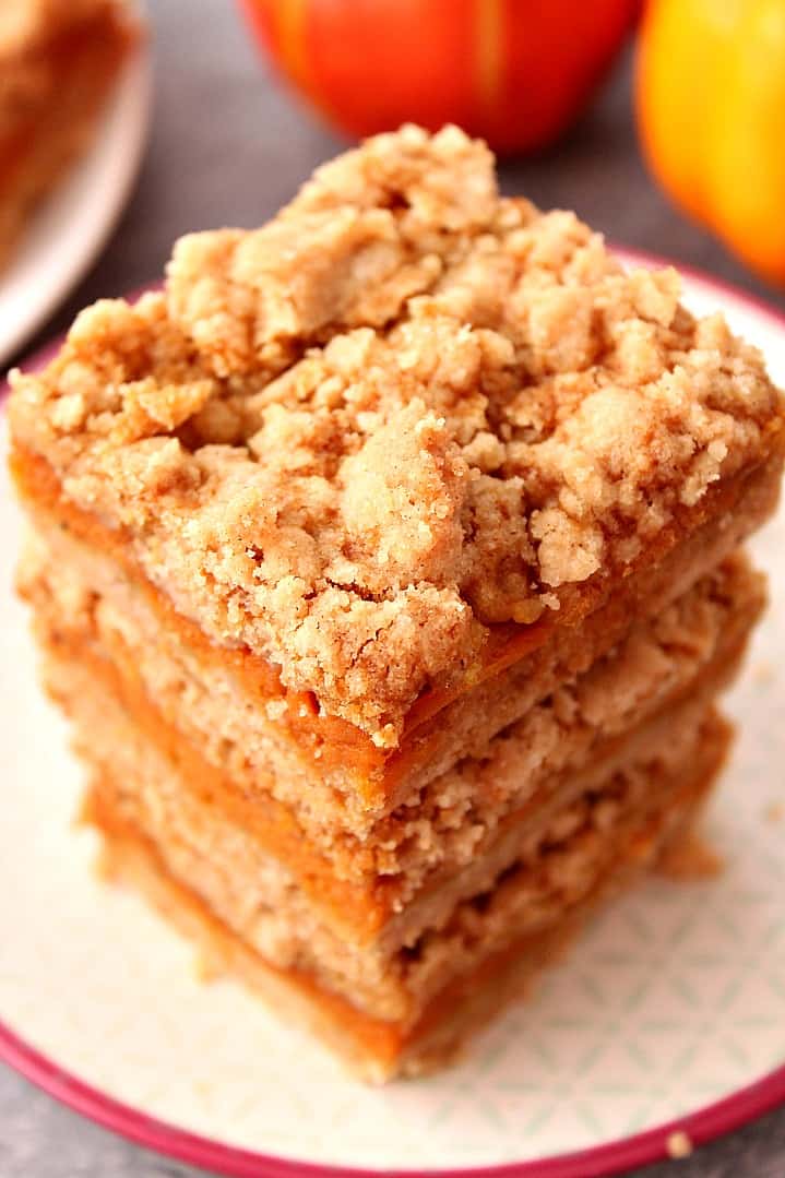 Overhead shot of a stack of three pumpkin pie bars squares.