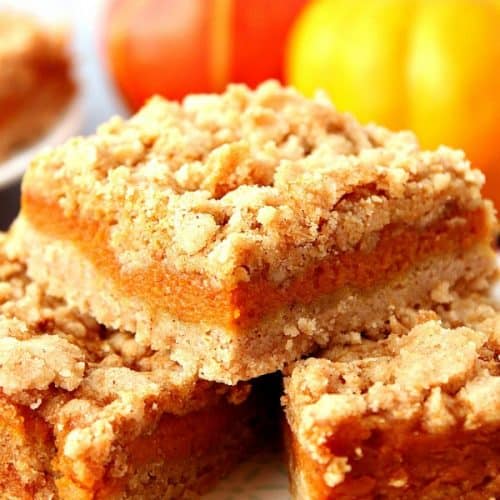 Pumpkin Pie Bars stacked on plate.