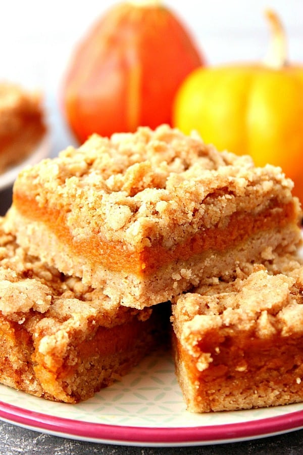 Pumpkin Pie Bars stacked on plate.