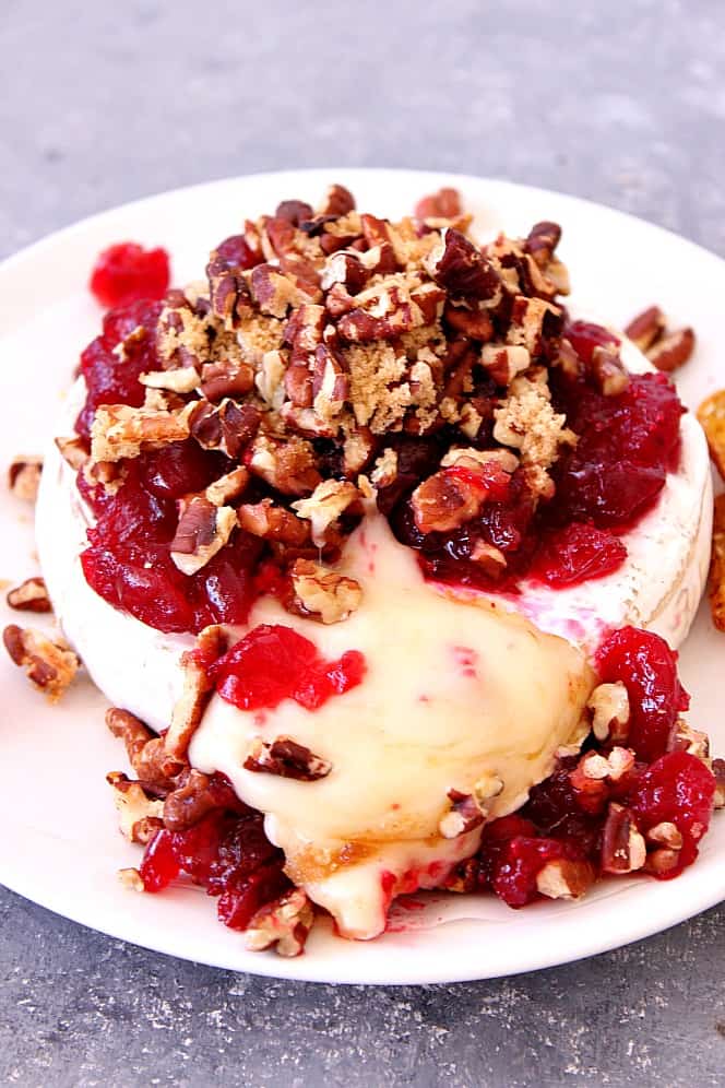 Cranberry Pecan Baked Brie Recipe - creamy gooey cheese topped with tarty cranberries and sweet pecans. Perfect party appetizer for the holiday season! 