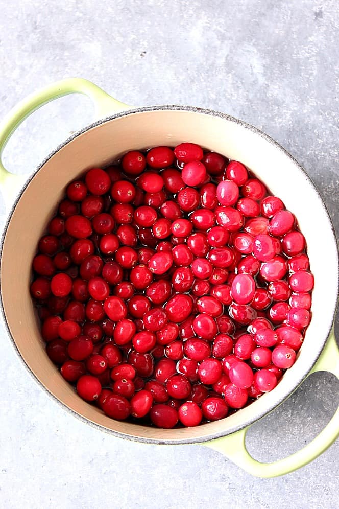 Fresh cranberries for Homemade Cranberry Sauce in water in a pot.
