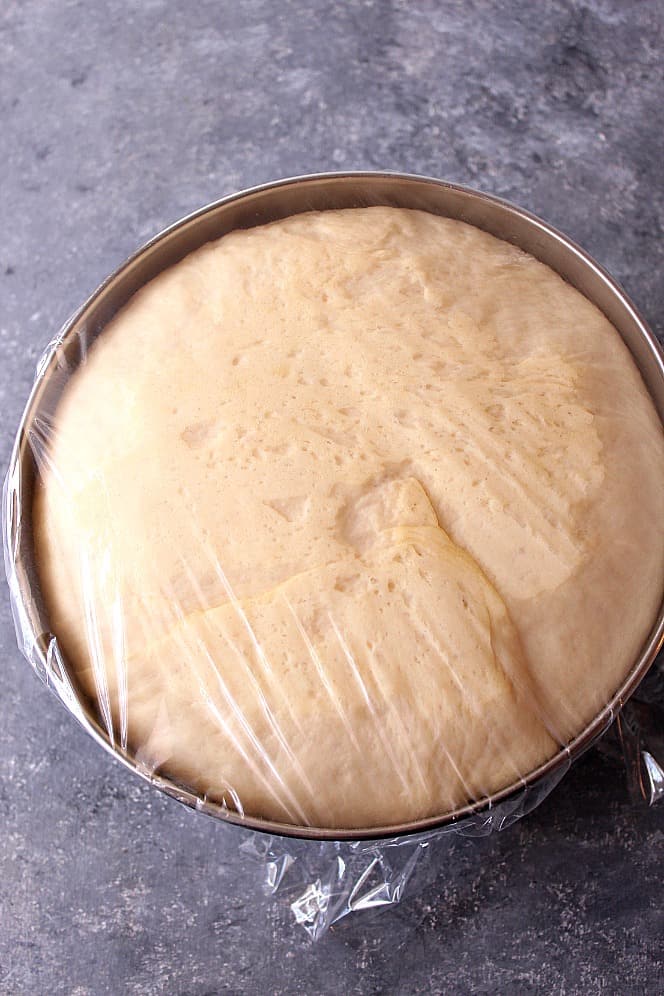 Yeast dough rising in a bowl for Dinner Rolls recipe.