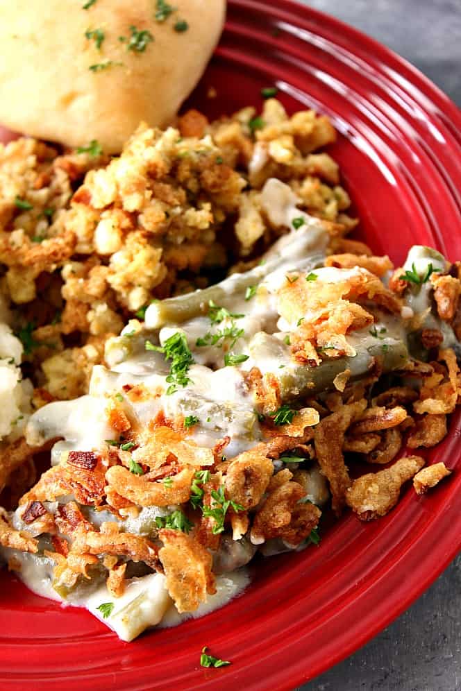 Slow cooker green beans on a plate with stuffing.