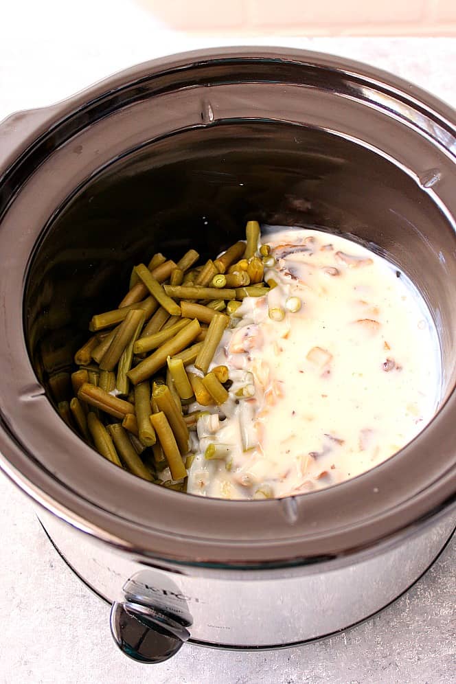 Ingredients for green bean casserole in a slow cooker.