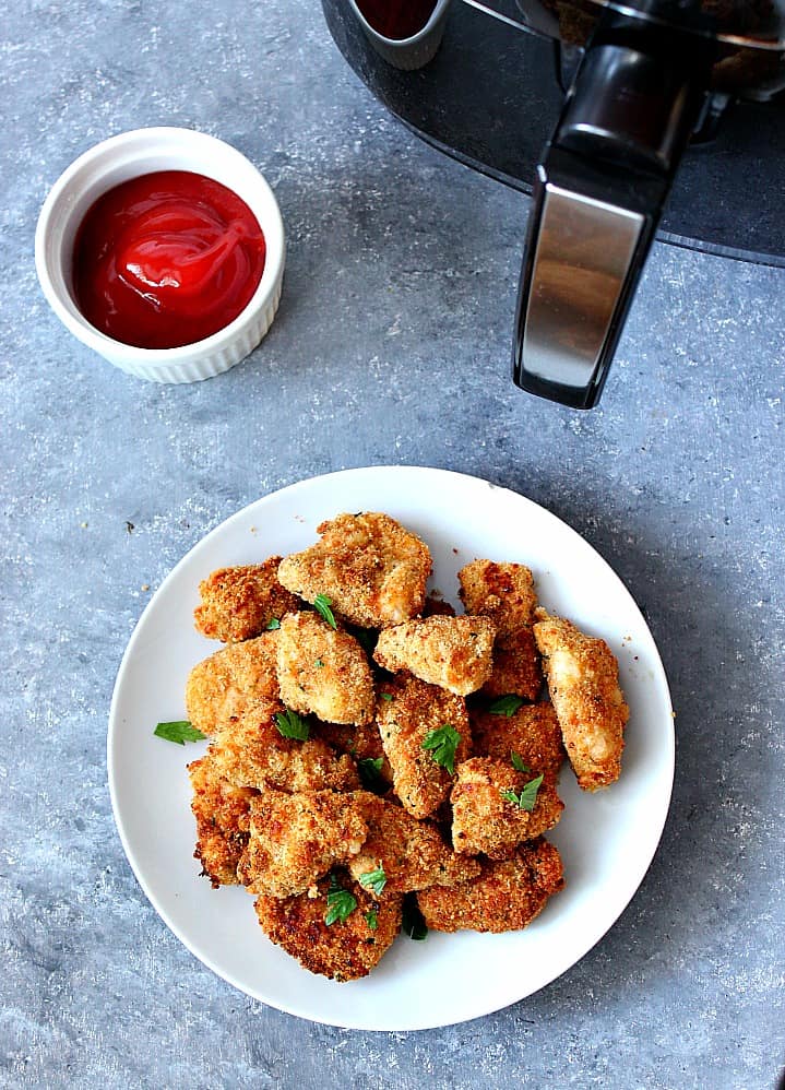 Air Fryer Chicken Nuggets Recipe - healthier option for a kid-friendly dinner! Easy homemade chicken nuggets, breaded and baked in an air fryer.