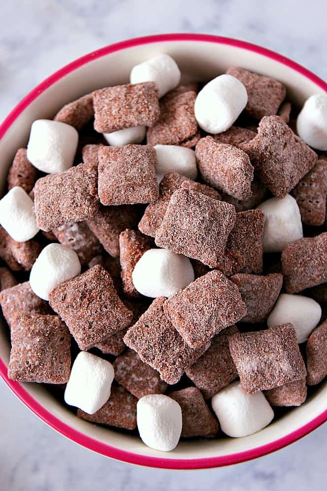 Hot Cocoa Muddy Buddies Recipe - rice cereal coated with milk chocolate and tossed in hot cocoa mix! Quick and easy snack idea to munch on this winter! 