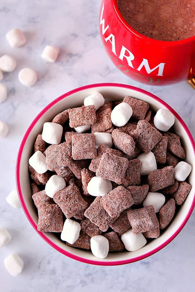Hot Cocoa Muddy Buddies Recipe - rice cereal coated with milk chocolate and tossed in hot cocoa mix! Quick and easy snack idea to munch on this winter! 