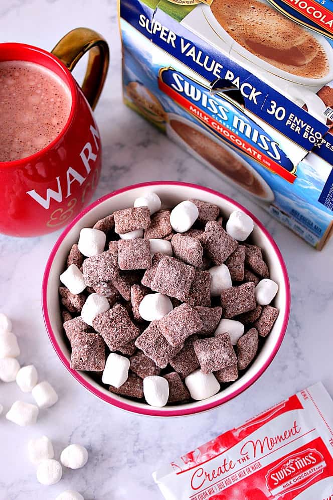 Hot Cocoa Muddy Buddies Recipe - rice cereal coated with milk chocolate and tossed in hot cocoa mix! Quick and easy snack idea to munch on this winter! 