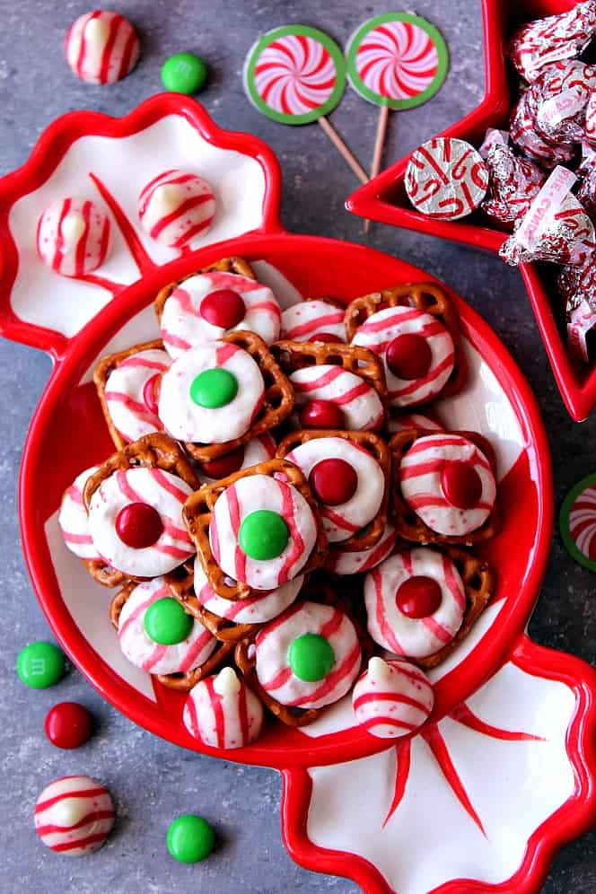 Peppermint Pretzel Candy recipe - crunchy pretzels topped with peppermint Kisses candy and M&M's makes for a festive holiday treat that is fun to make and eat!