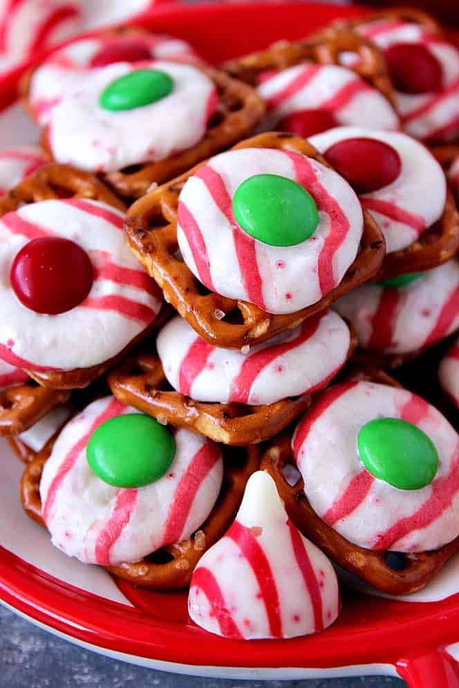 Peppermint Pretzel Candy recipe - crunchy pretzels topped with peppermint Kisses candy and M&M's makes for a festive holiday treat that is fun to make and eat!