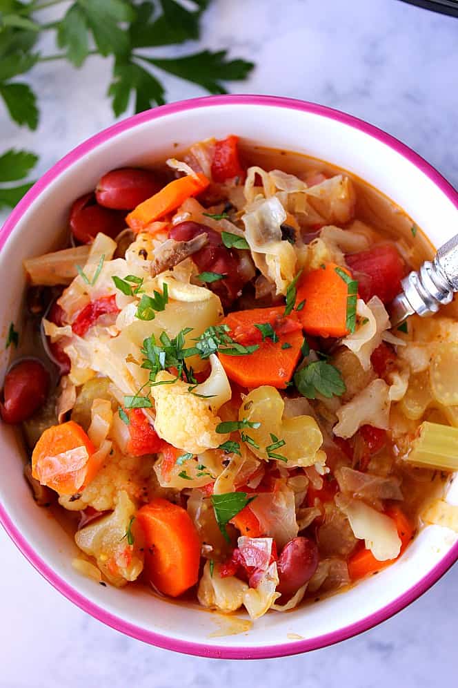 Instant Pot vegetable soup in a bowl with spoon. 