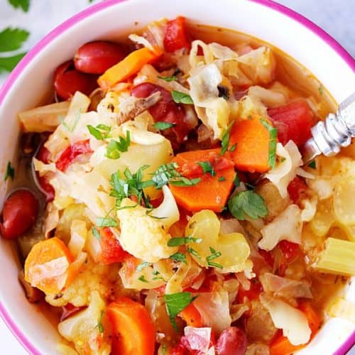 Instant Pot Vegetable soup in a bowl with spoon.