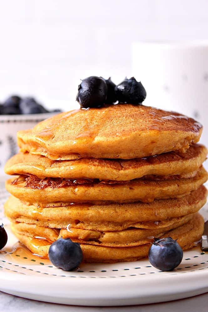 Fluffy pancakes stacked on a plate.