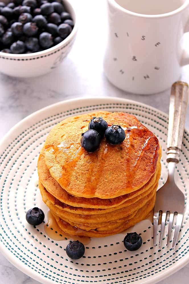 Pancakes with blueberries on a plate.