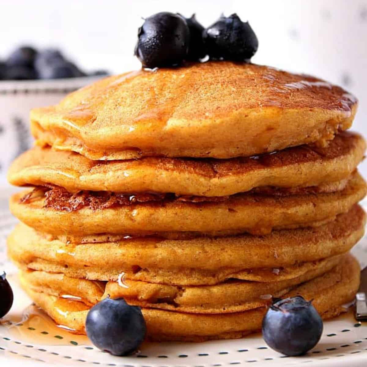 Pancakes stack on a plate.