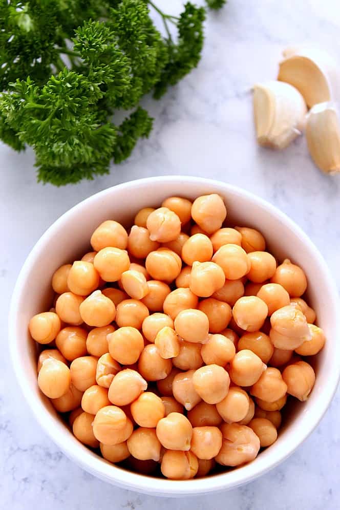 Easy Hummus without Tahini - simple recipe for hummus made with just a few ingredients and no tahini. So much better than store-bought stuff. garbanzo beans in bowl