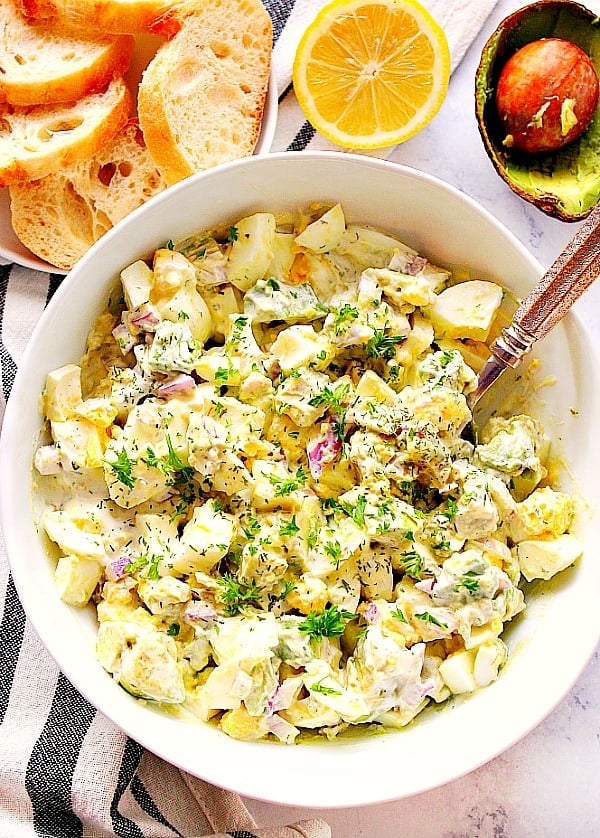 Overhead shot of egg salad in white bowl.